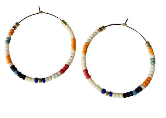 Colorful beaded hoop earrings on a white background.