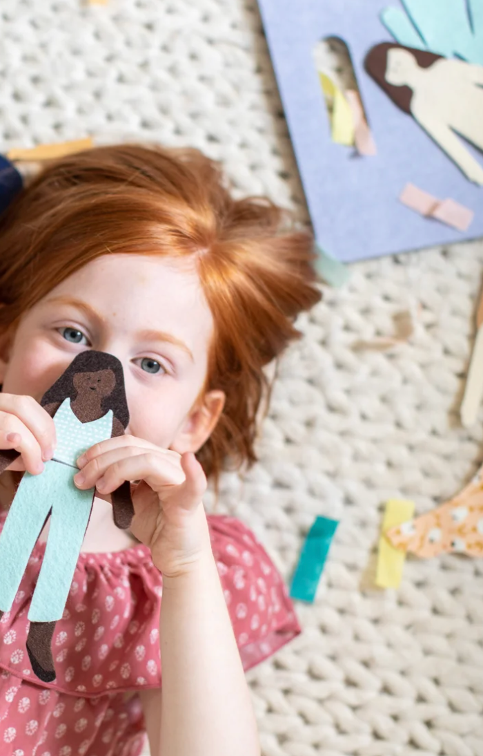 Girl holding ‘Cocoa Felt Doll’ 