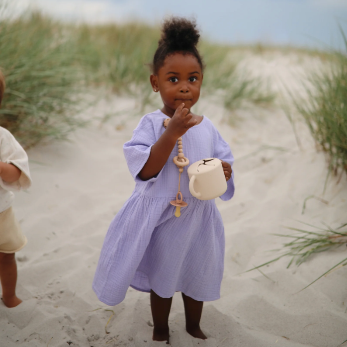 Young girl holding reusable snack cup