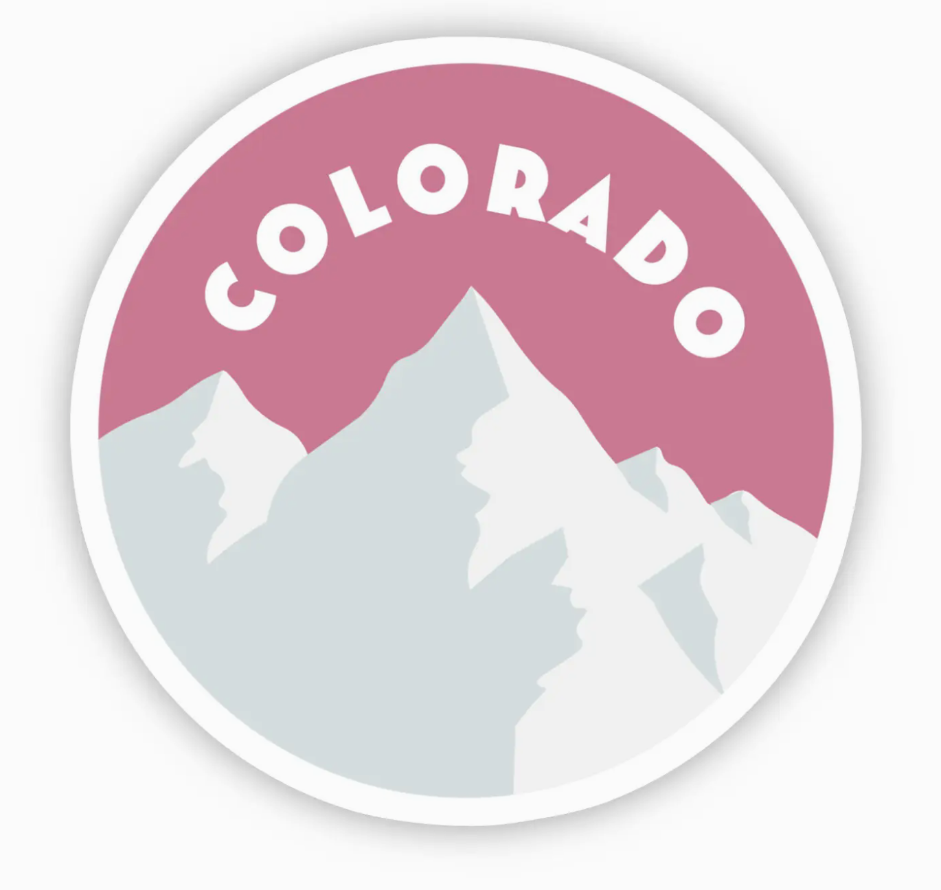 Circular sticker with 'Colorado' text and mountain silhouette on a pink sky