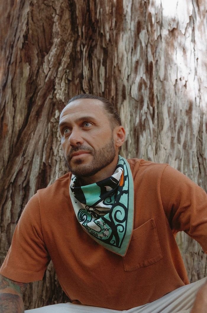 Man wearing a bandana around his neck