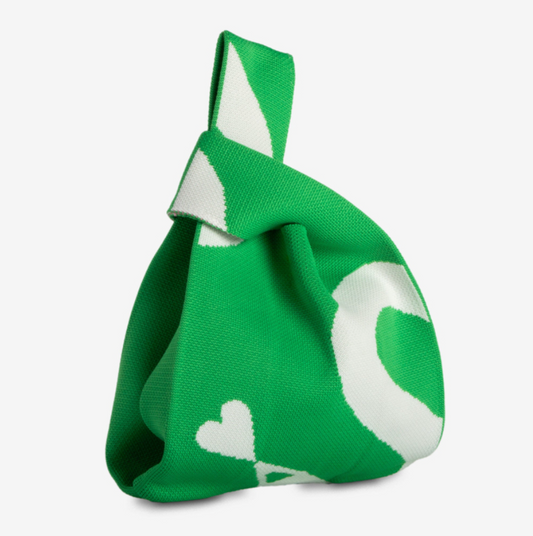 Green and white patterned bag on a light gray background