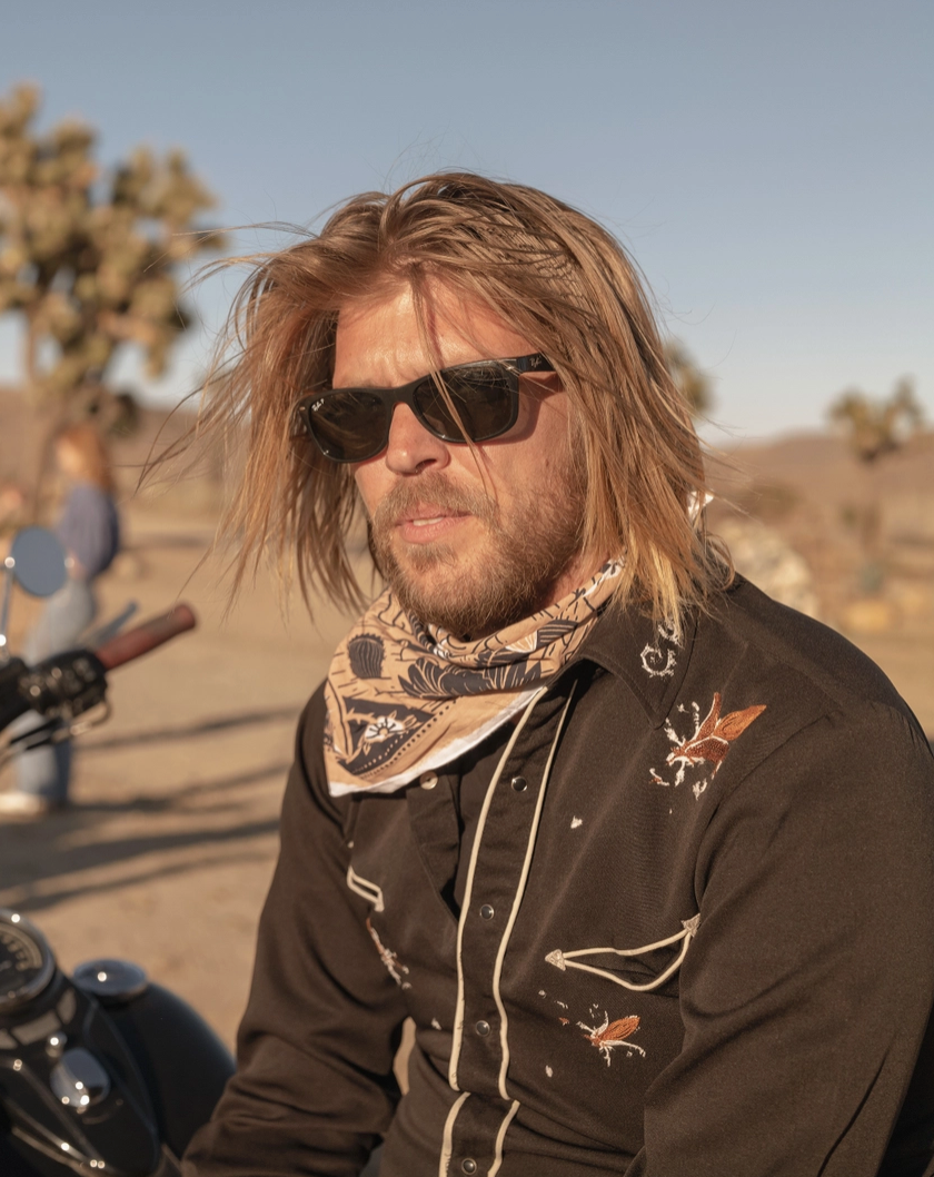 Man wearing bandana around his neck