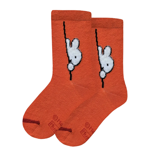 Orange socks with white bunny Miffy designs on a light gray background