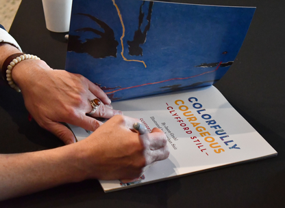 Author signing a copy of ‘Colorfully Courageous Clyfford Still’