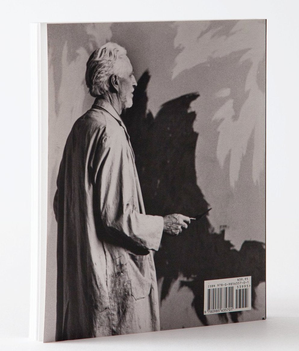 Back cover of ‘Clyfford Still: The Artist's Museum’ featuring a photo of Clyfford Still painting.
