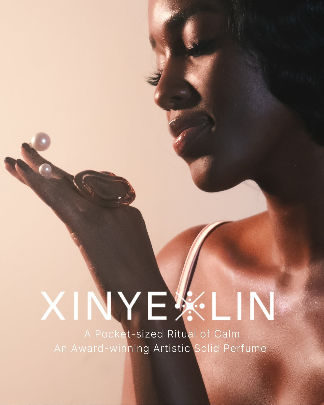 Woman holding a solid perfume with XINYE LIN branding and product description text.