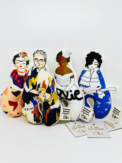 Four soft fabric rattles each with an illustration of a famous artist. From left to right: Frida Kahlo, Clyfford Still, Billie Holiday, and Prince. 