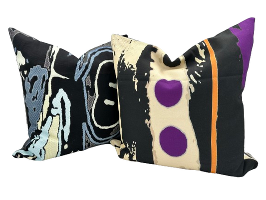 Two abstract pillow covers with vibrant shapes and colors created by Katy Kidd. 