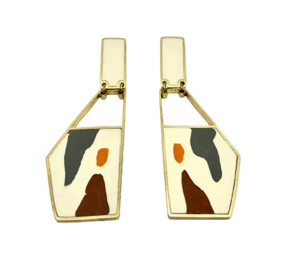 Pair of geometric earrings with abstract design on a white background