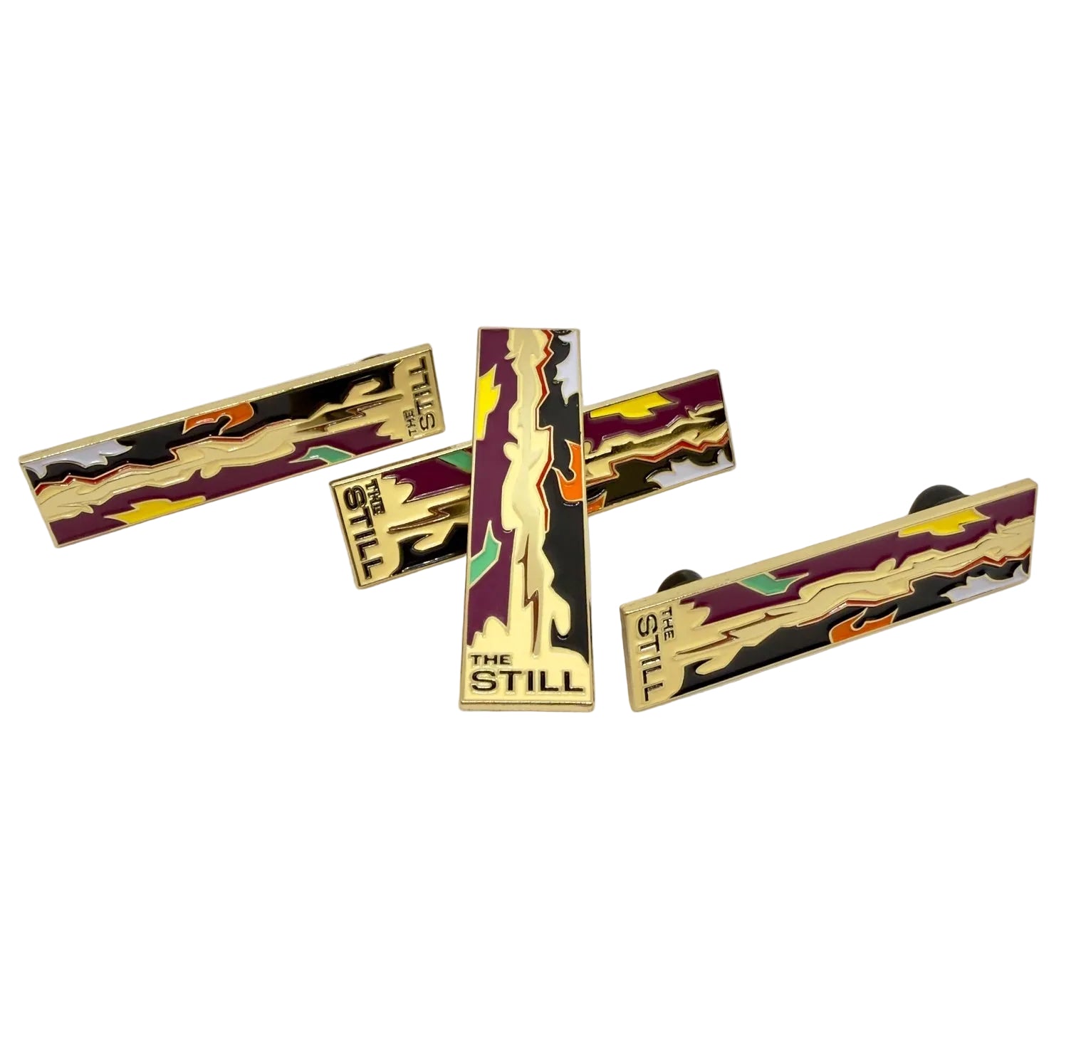 Set of 'The Still' branded lifeline pins on a light background