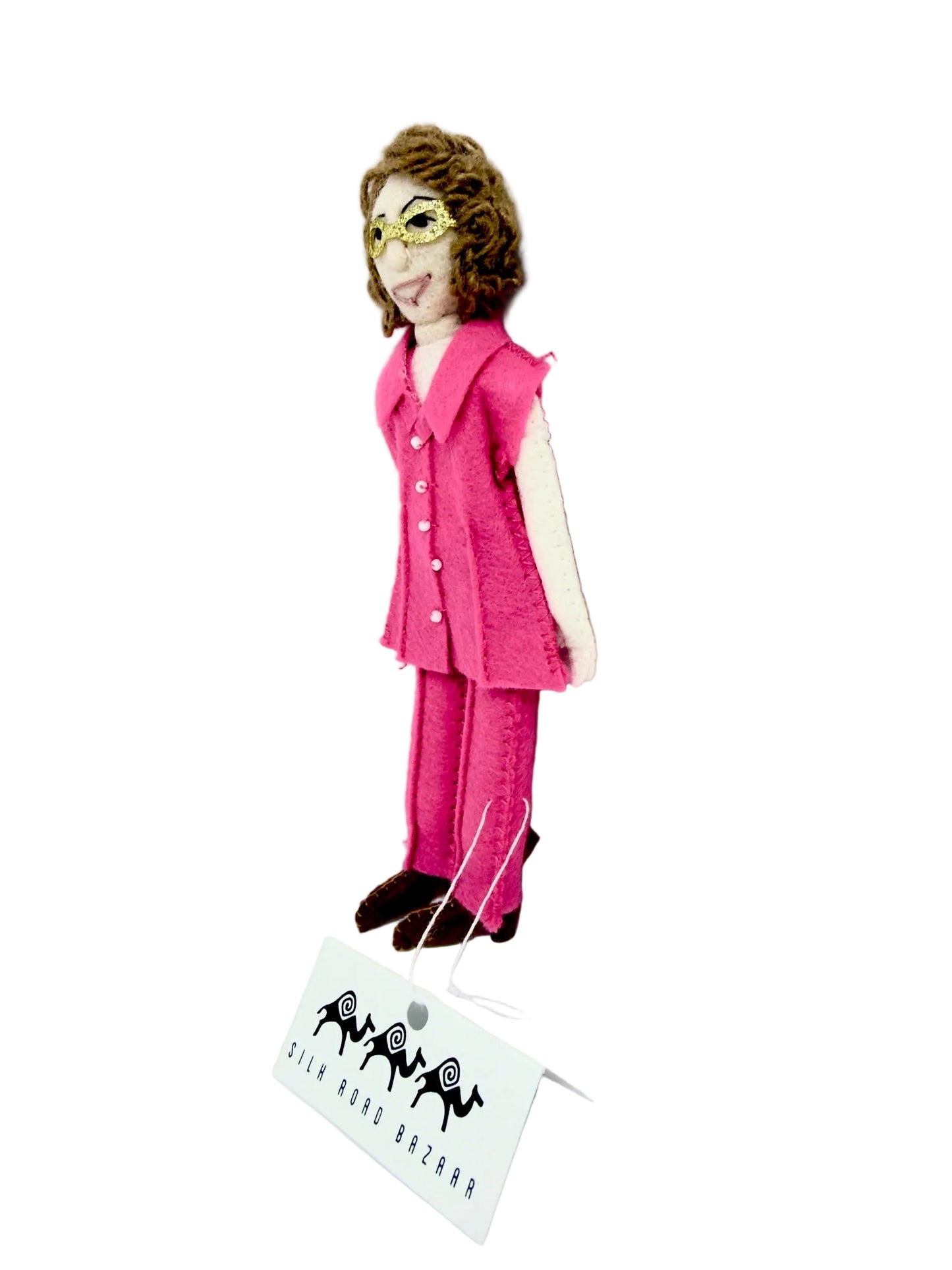 Felt figure of a person wearing a pink outfit with a visible brand tag on a white background