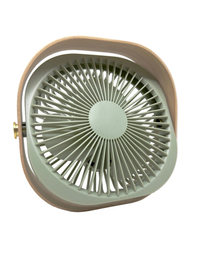 A retro-style portable fan with a sage green front grille and a beige outer frame, shown against a plain white background.