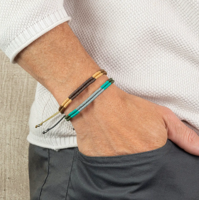 Close-up photo of a man wearing two Macrame Surfer Bracelets