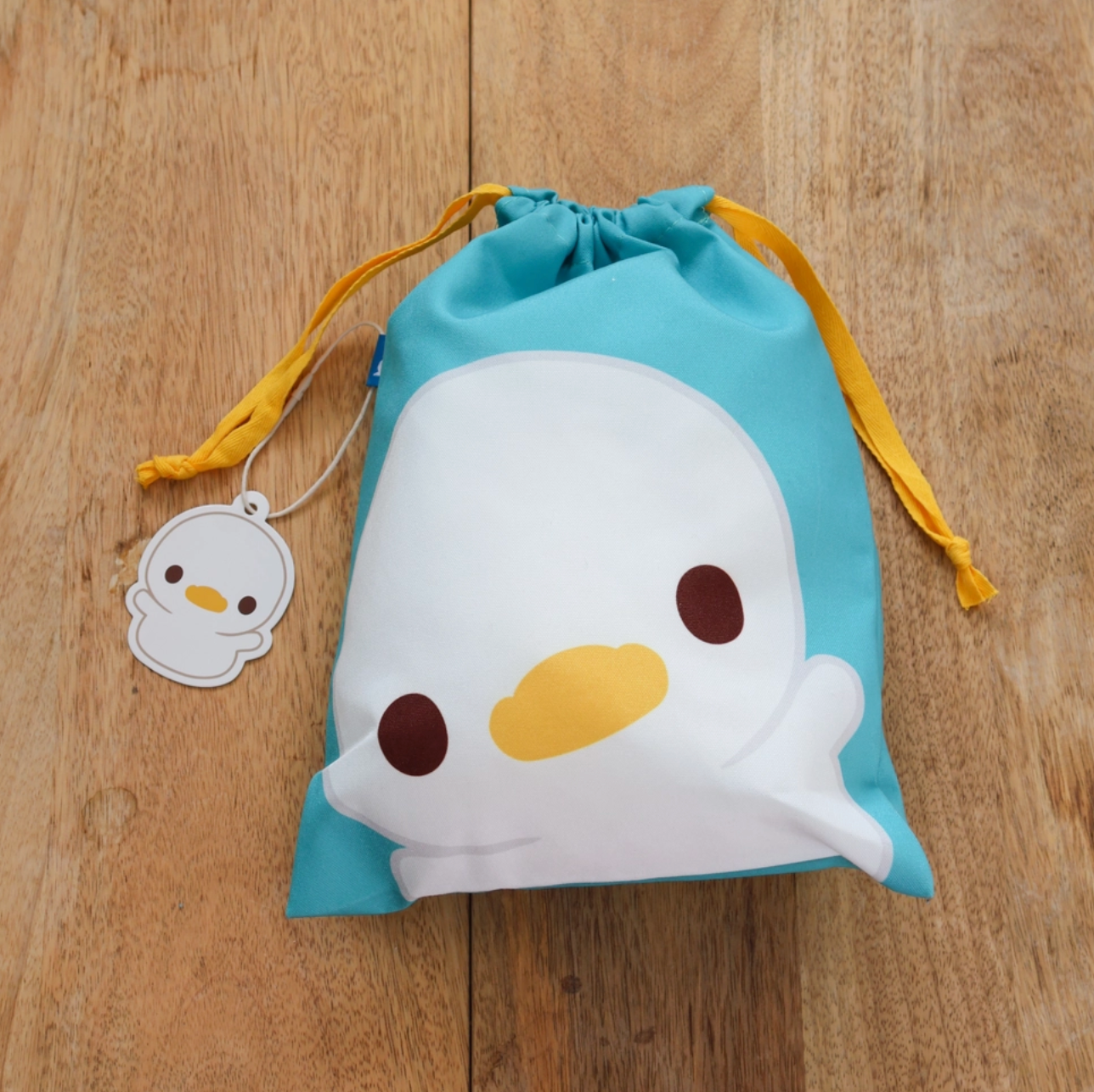 A travel-friendly, cute, versatile drawstring pouch bag with a duckling.