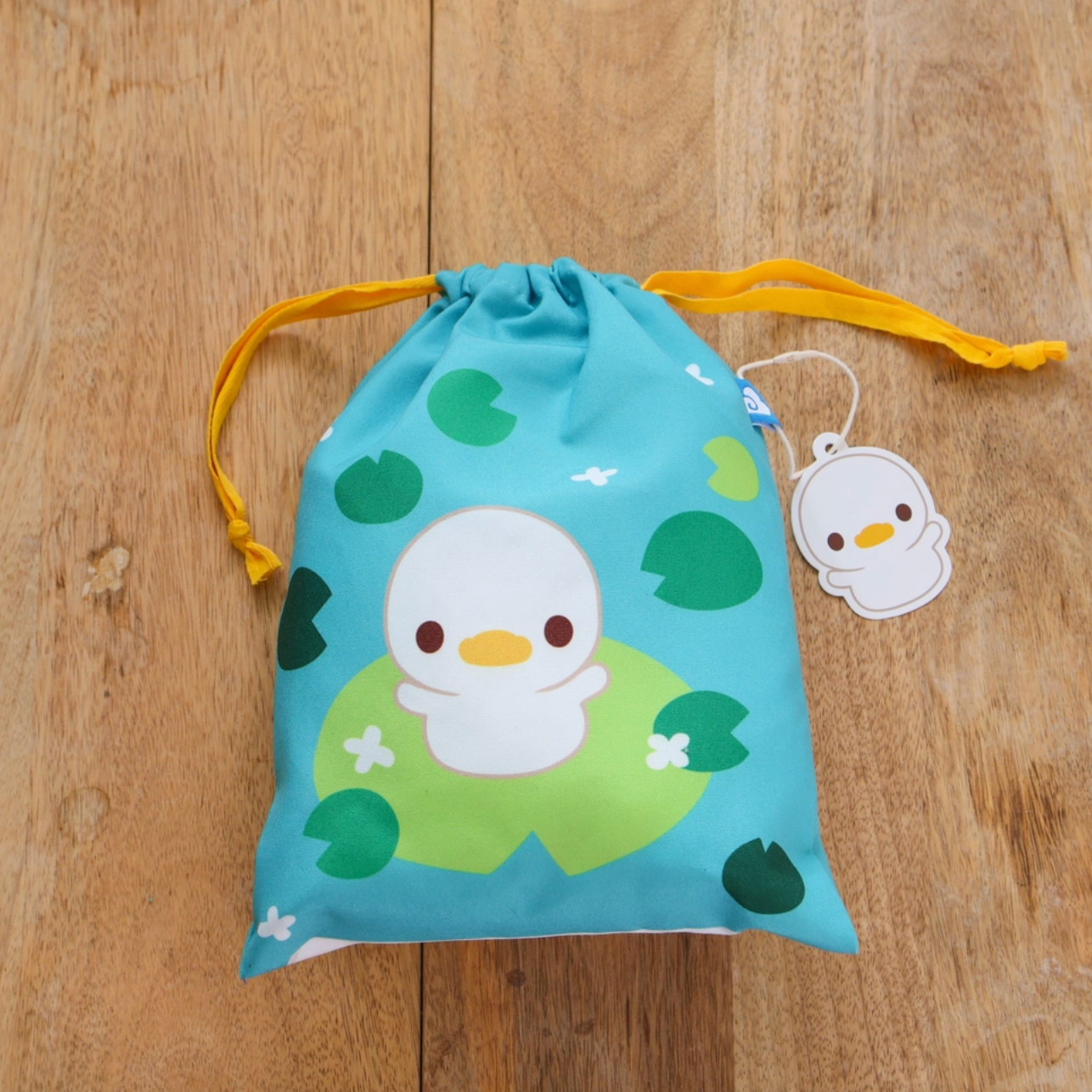 A travel-friendly, cute, versatile drawstring pouch bag with a duckling.