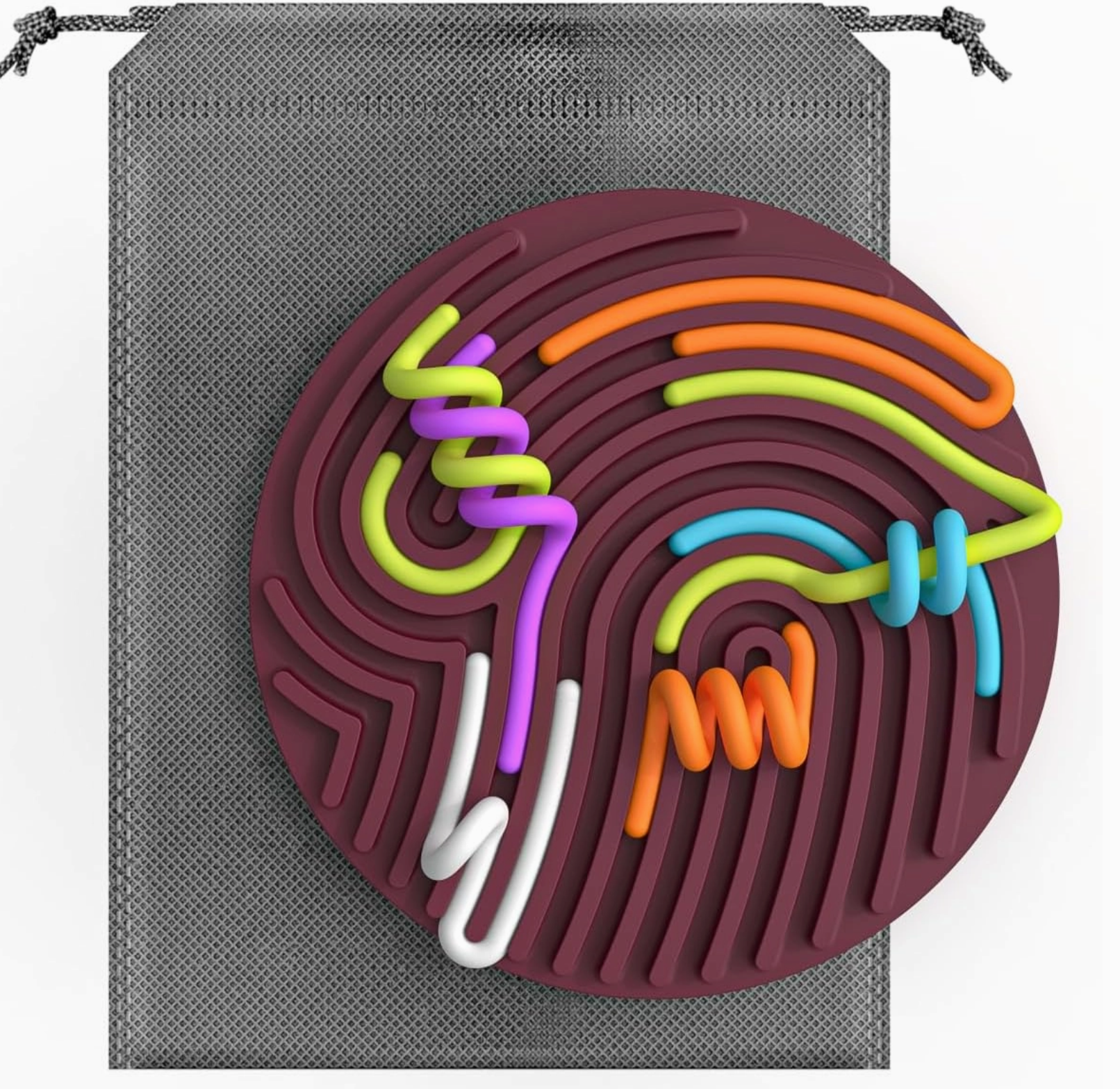 Colorful silicone coaster with abstract design on a gray drawstring bag.