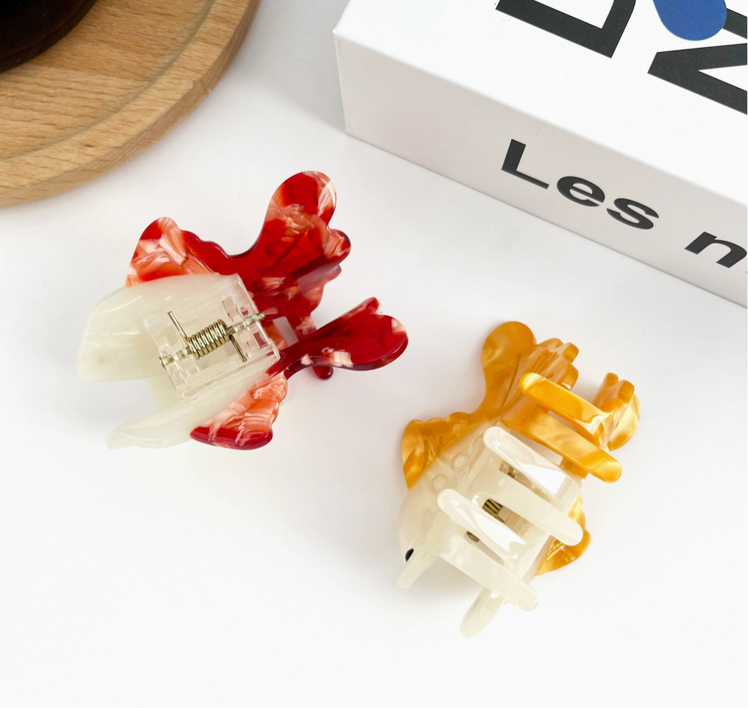 Two colorful hair clips on a white.