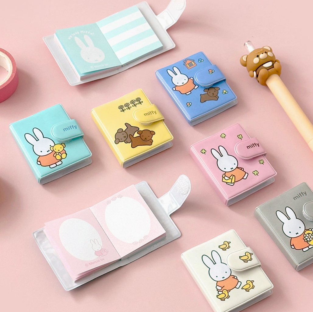 Set of small notebooks with the Miffy character designs on a pink background.