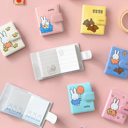 Collection of small notebooks with the Miffy character designs on a pink background.