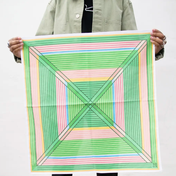 Person holding a colorful geometric patterned scarf