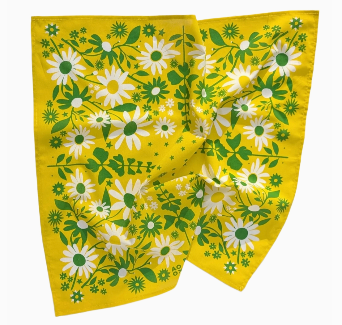 Floral patterned bandana with white flowers and green leaves on a yellow background
