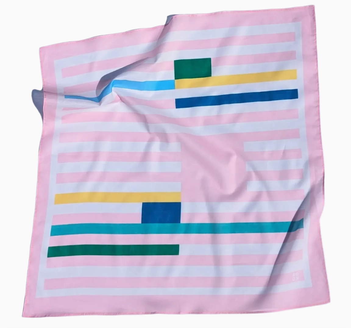 Pink bandana with colorful geometric patterns on a white background