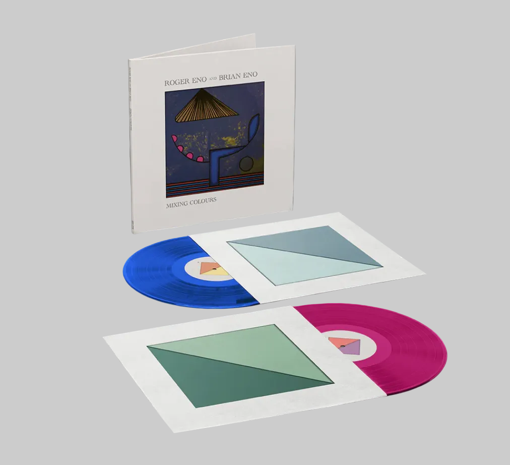 Vinyl records with colorful covers and a white album cover on a gray background.