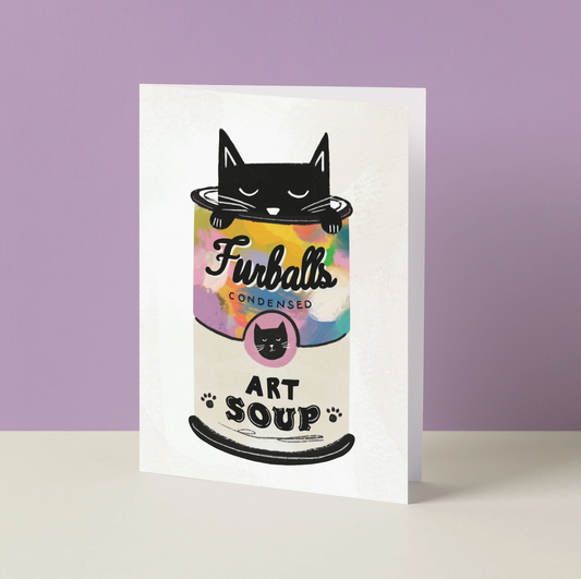 Greeting card with a cat-themed can of 'Furballs Art Soup' on a purple background