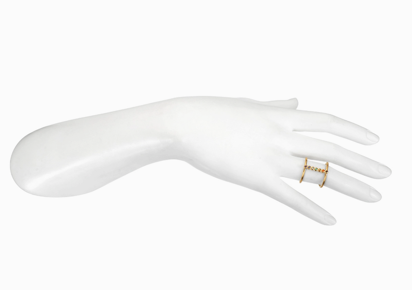 White mannequin hand wearing a gold ring on a white background