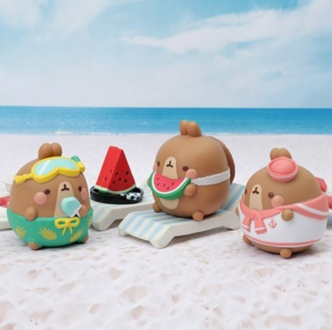 Three cartoon-style figurines on a beach.