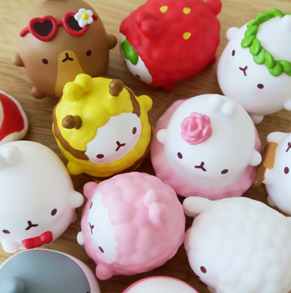 Collection of cute, colorful squishy toys on a wooden surface