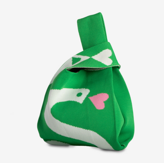Green and white Knitted Knot Bag with a snake and pink heart on a white background.