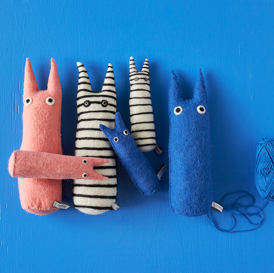 6 fabric monsters with different colors and patterns on a blue background