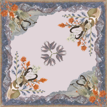 Decorative scarf with antelope heads and floral elements on a blue background