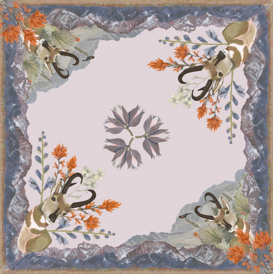 Decorative scarf with antelope heads and floral elements on a blue background