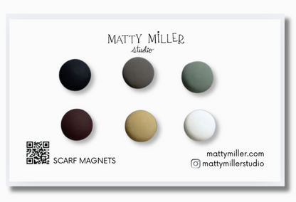 Set of scarf magnets in various colors with Matty Miller Studio branding.