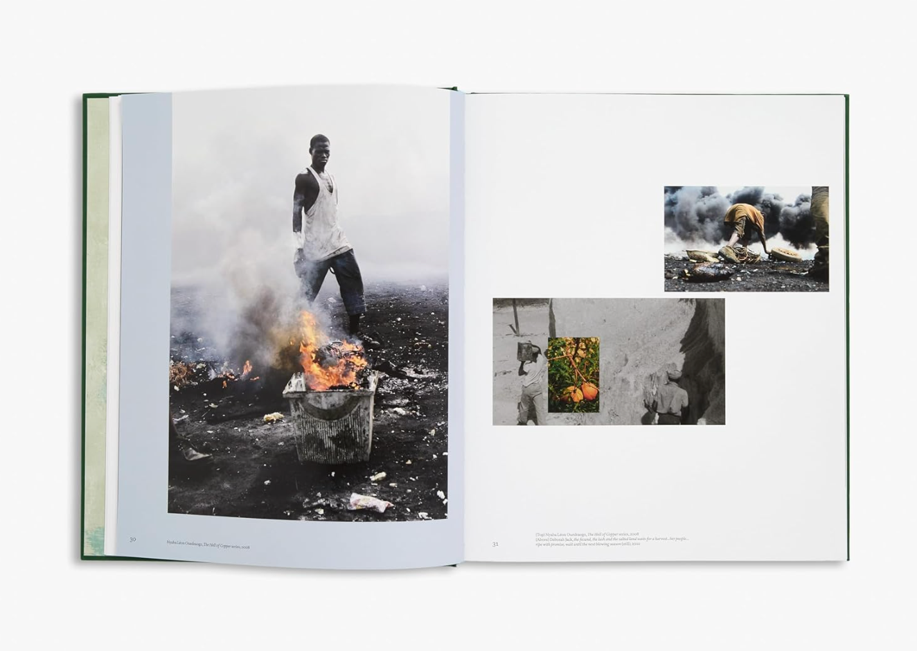 Open book displaying black and white photographs of a person near a fire.