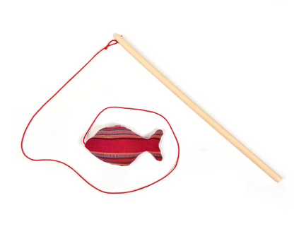 Red Cat fish toy with a string and wooden rod on a white background