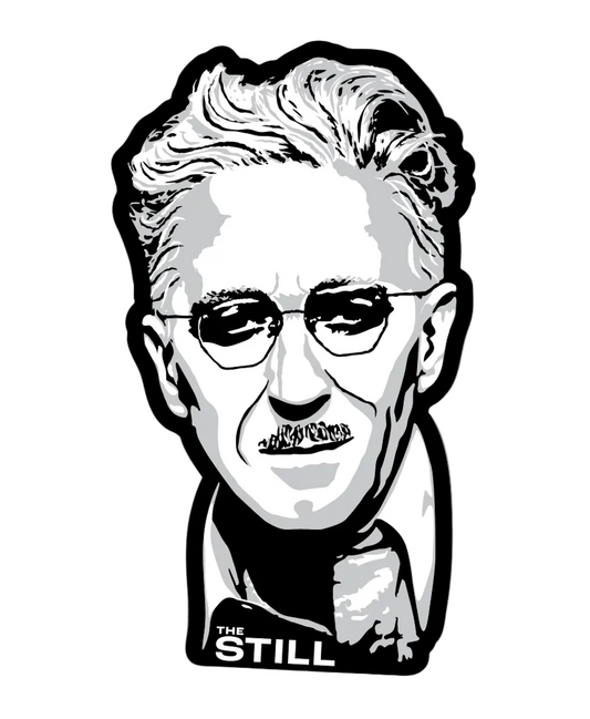 A die-cut vinyl sticker featuring a stylized black and white graphic portrait of a man with glasses and the text 'THE STILL' at the bottom, shown on a light gray background.