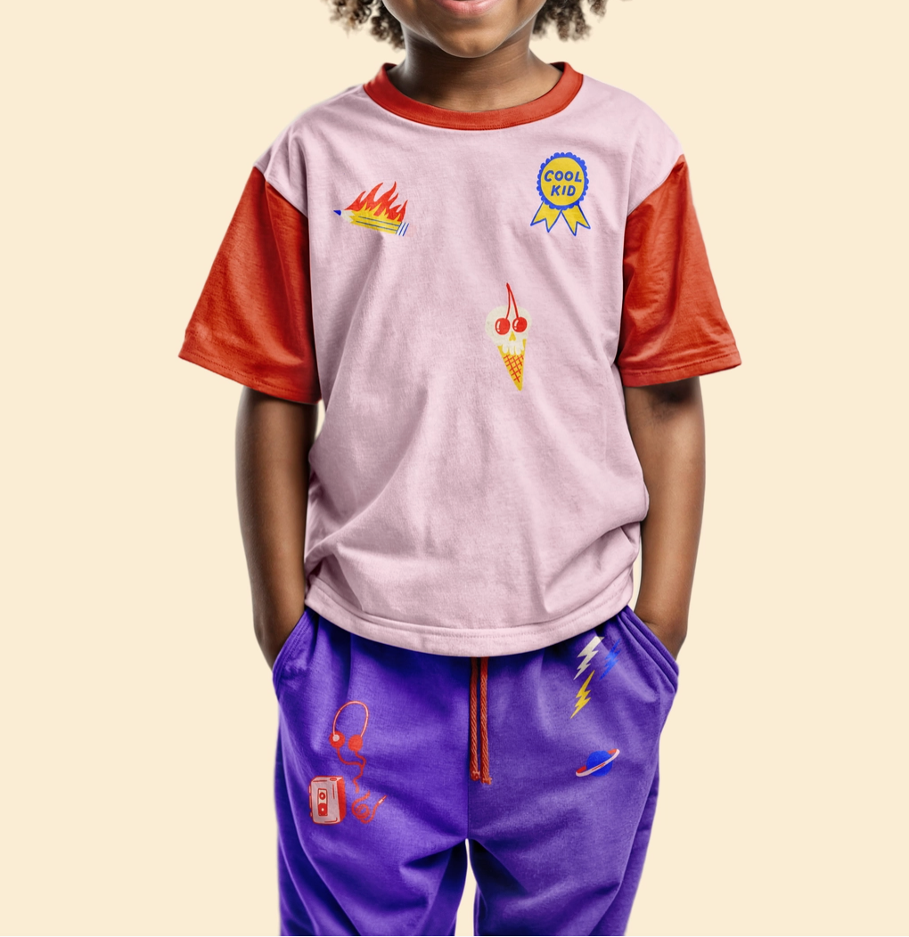Child wearing a colorful outfit with graphics on a beige background.