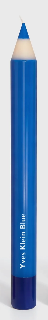 Blue candle with white top labeled 'Yves Klein Blue' on a white background