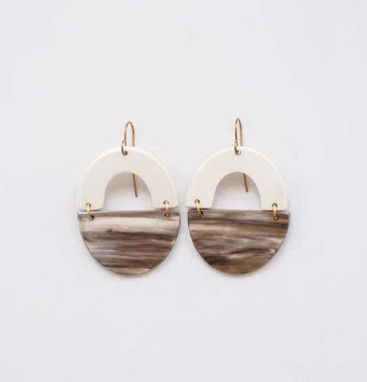 Pair of earrings with marbled design on a light gray background