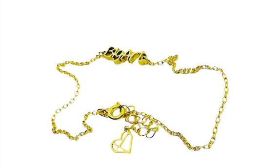Delicate gold chain with a with a word charm reading ’BigArt’